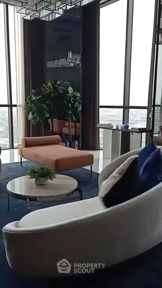 Luxurious high-rise living room with panoramic city views and modern furnishings.