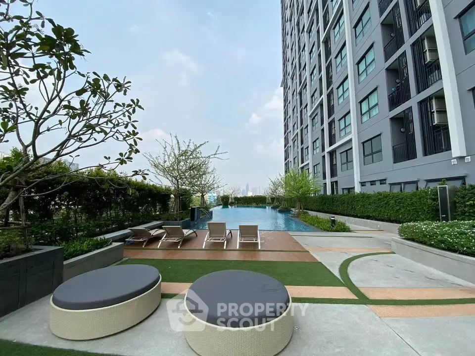 Luxurious high-rise condo with stunning pool and lush garden view.