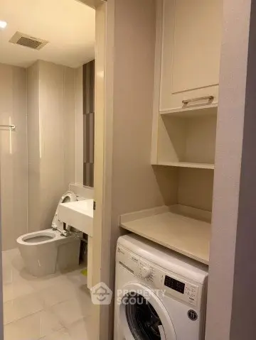 Modern bathroom with washing machine and sleek fixtures
