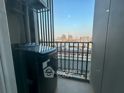 Compact balcony with washing machine and city view, perfect for urban living convenience.