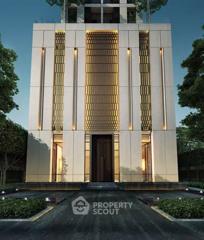 Stunning modern building facade with elegant lighting and lush greenery, perfect for luxury urban living.