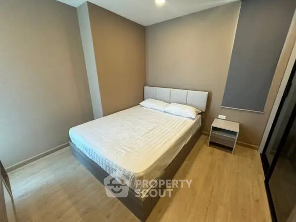 Cozy bedroom with modern design and wooden flooring