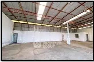 Spacious industrial warehouse with high ceilings and ample natural light.