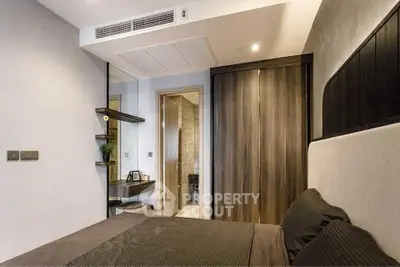 Modern bedroom with sleek design and wooden accents, featuring a cozy bed and built-in wardrobe.