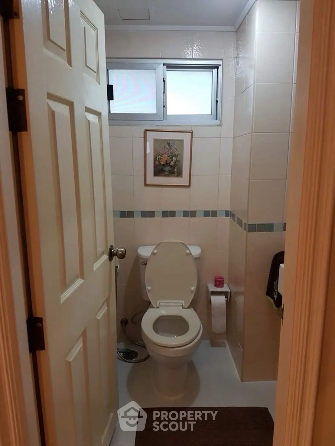Cozy bathroom with modern fixtures and tasteful wall art, ideal for compact spaces.