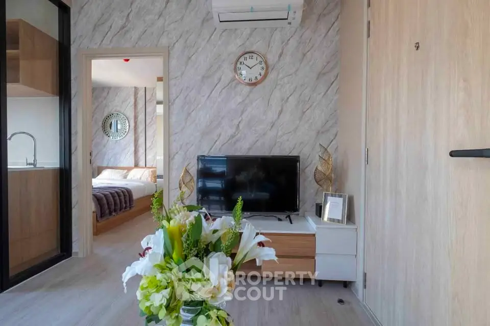 Modern living room with stylish decor and open view to bedroom