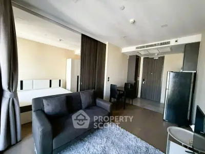 Modern studio apartment with open layout, featuring a cozy living area and stylish furnishings.