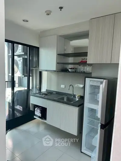 Modern compact kitchen with open layout and sleek appliances