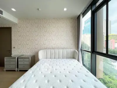 Bright bedroom with large windows and modern decor in urban apartment