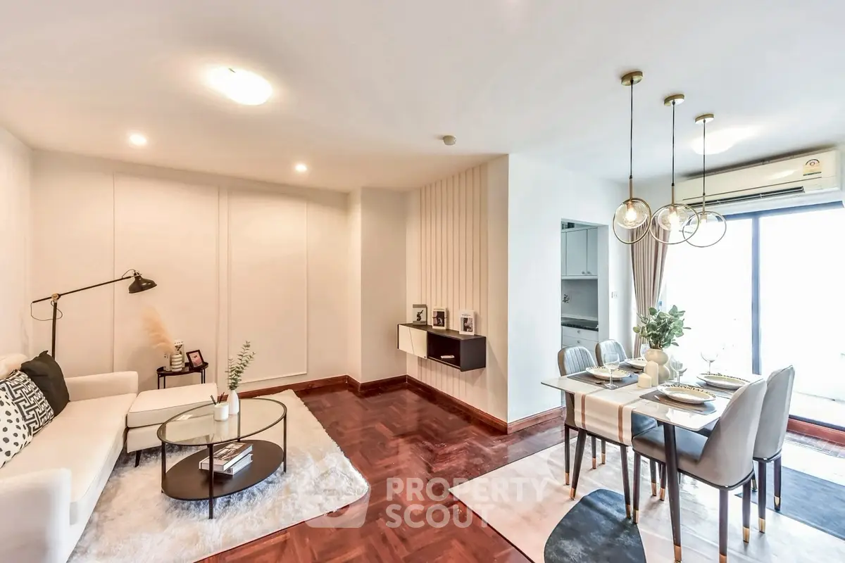 Elegant living and dining area with modern decor and natural light