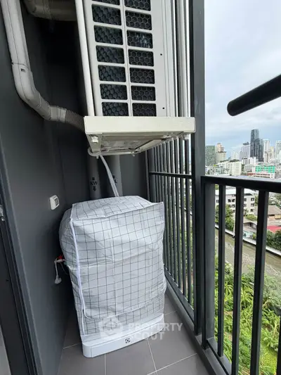 High-rise balcony with city view and air conditioning unit