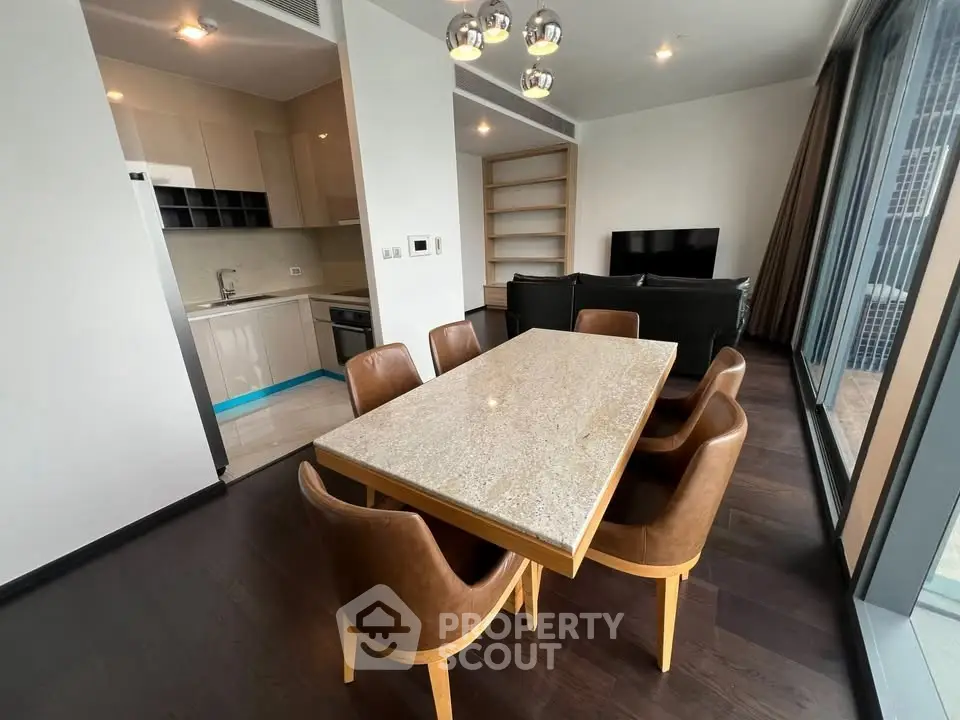 Modern open-plan living and dining area with sleek kitchen and stylish furnishings.