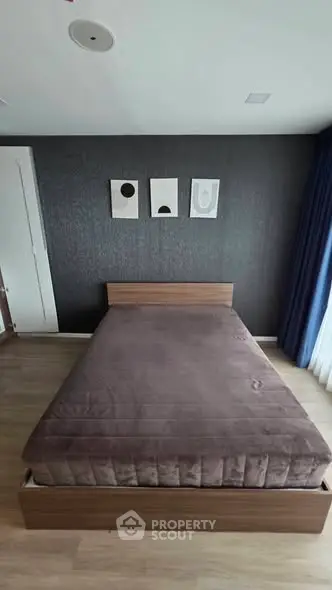 Modern bedroom with stylish decor and cozy bed in a contemporary apartment.