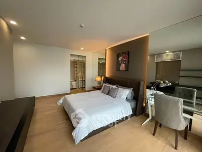 Spacious modern bedroom with elegant decor and natural lighting