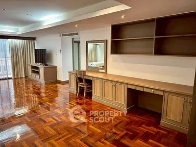 Spacious living room with elegant wooden flooring and built-in furniture, perfect for modern living.