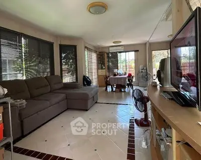 Spacious living room with modern decor and large windows for natural light.