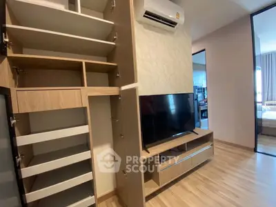 Modern living room with built-in storage and TV unit, showcasing sleek design and functionality.