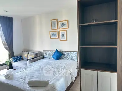 Modern bedroom with stylish decor and natural light, featuring a cozy bed and elegant shelving.