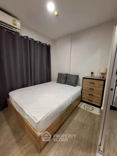 Cozy bedroom with modern furnishings and wooden flooring