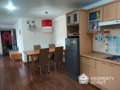 Spacious kitchen with dining area and modern appliances in a cozy apartment