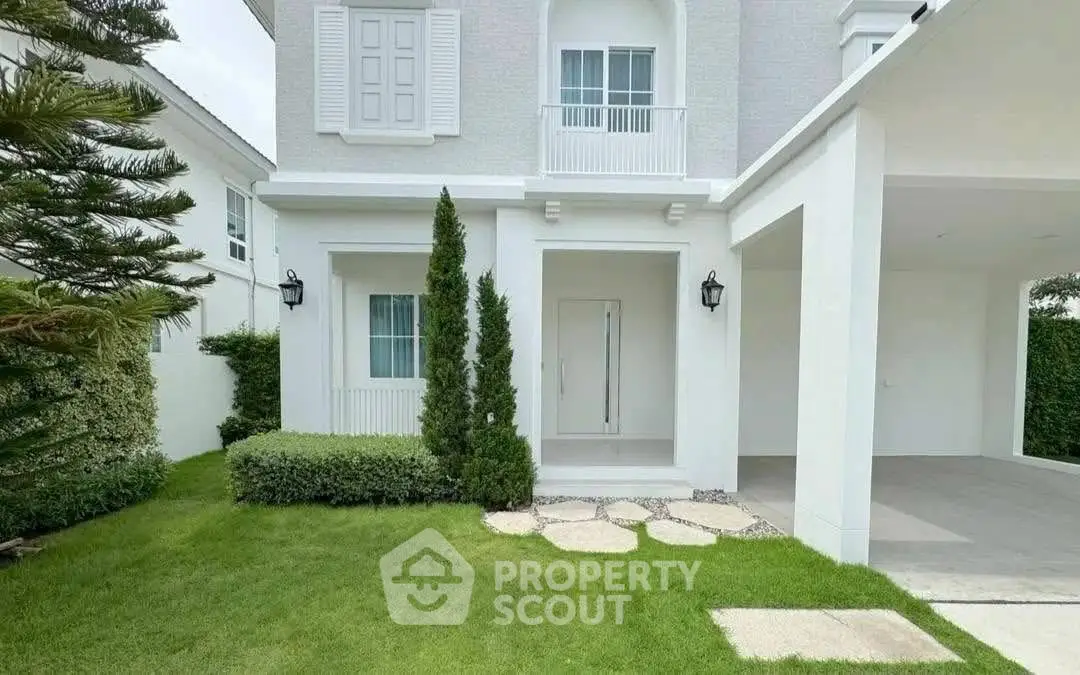 Elegant white house exterior with manicured lawn and modern design