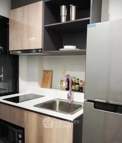 Modern compact kitchen with sleek appliances and stylish cabinetry