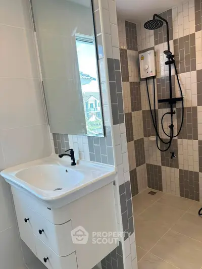 Modern bathroom with stylish shower and sleek sink in contemporary home.