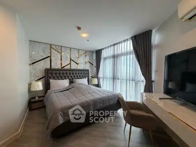 Luxurious bedroom with elegant decor, large window, and modern furnishings in a high-end apartment.