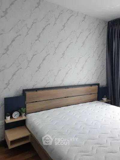 Modern bedroom with stylish headboard and elegant wallpaper