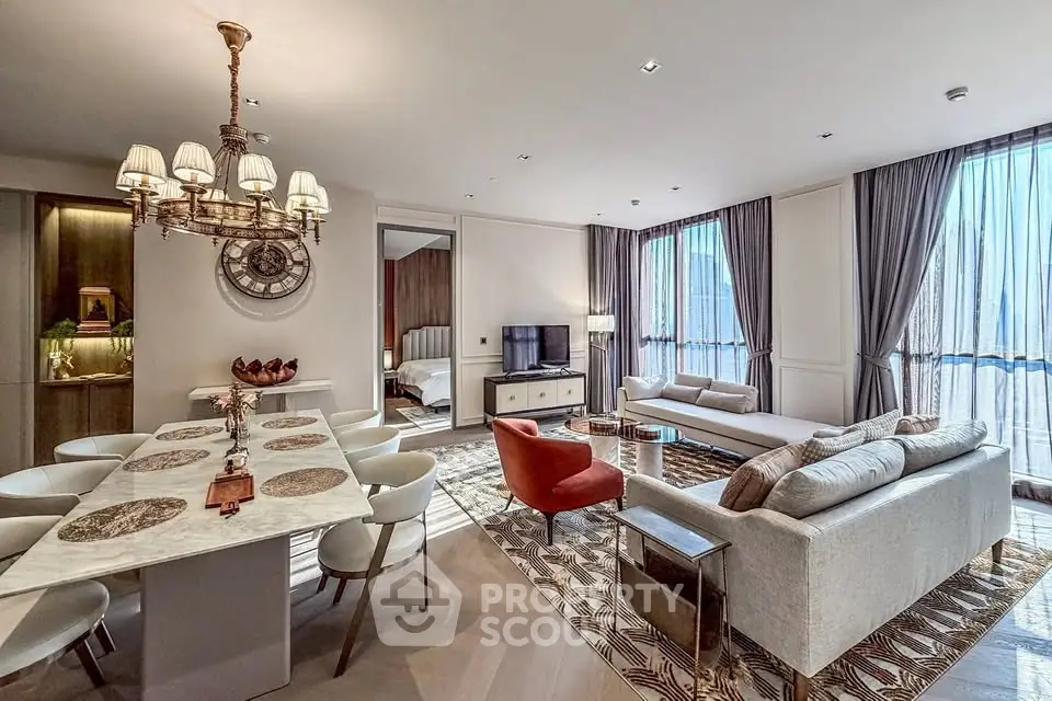 Luxurious open-plan living and dining area with elegant decor and large windows.