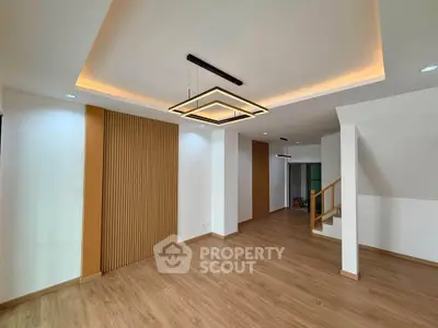 Spacious modern living room with stylish lighting and wooden flooring