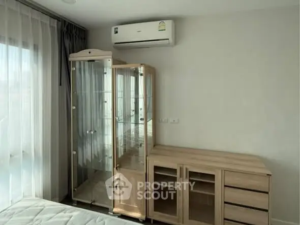 Modern bedroom with glass cabinet and air conditioning unit