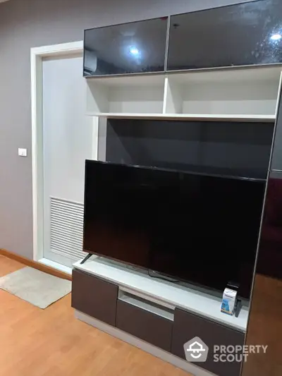 Modern living room with sleek TV unit and storage cabinets