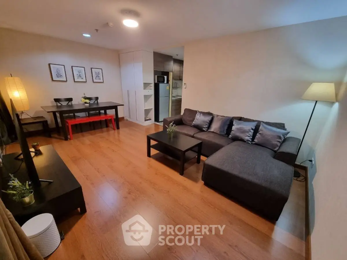 Spacious modern living room with cozy sectional sofa and elegant dining area, perfect for entertaining.