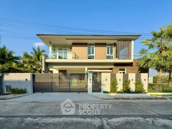 Modern two-story house with sleek design and spacious balcony in a serene neighborhood.