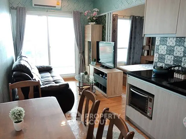 Charming living room with modern kitchen and cozy seating area, perfect for relaxation and entertainment.