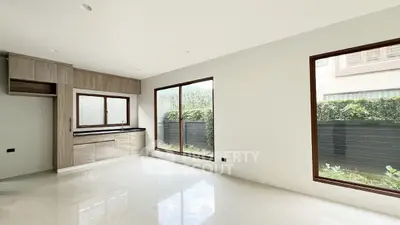 Spacious modern living room with large windows and garden view