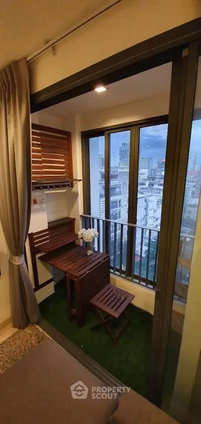 Charming urban balcony with wooden furniture and city view, perfect for relaxation and enjoying the skyline.