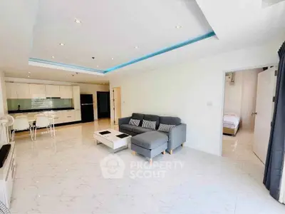 Spacious modern living room with open kitchen and sleek design