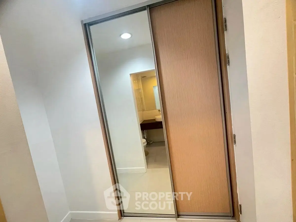 Modern bathroom with sliding door and sleek fixtures in a contemporary apartment.