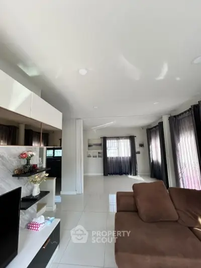 Spacious modern living room with sleek design and abundant natural light