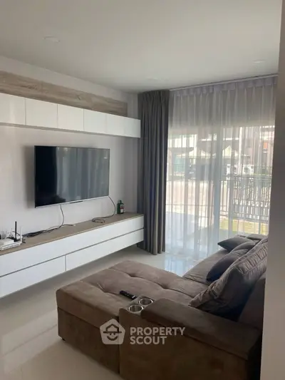 Modern living room with sleek TV setup and cozy sectional sofa, perfect for relaxation.