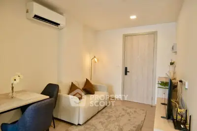 Cozy modern living room with stylish decor and air conditioning, perfect for relaxation.