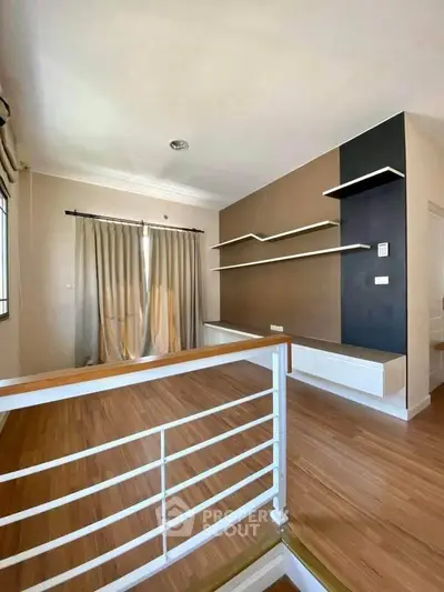 Modern living room with wooden flooring and stylish wall shelves