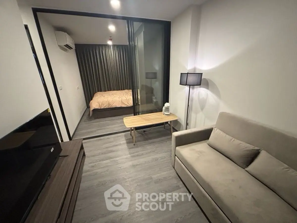 Modern studio apartment with cozy living area and bedroom
