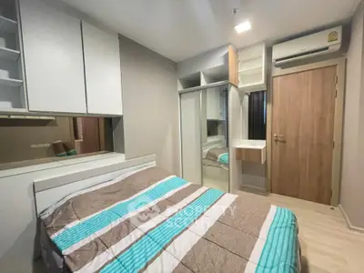 Modern bedroom with built-in wardrobe and air conditioning in stylish apartment