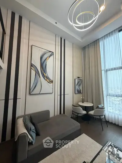 Modern living room with stylish decor and large windows offering city views.