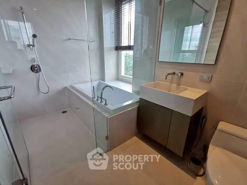 Modern bathroom with bathtub and sleek fixtures in a bright setting.