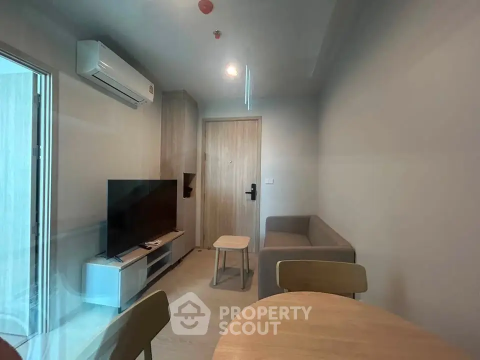 Modern living room with sleek furniture and natural light, perfect for cozy urban living.