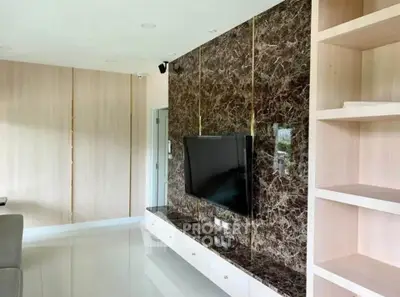 Modern living room with marble accent wall and built-in TV unit